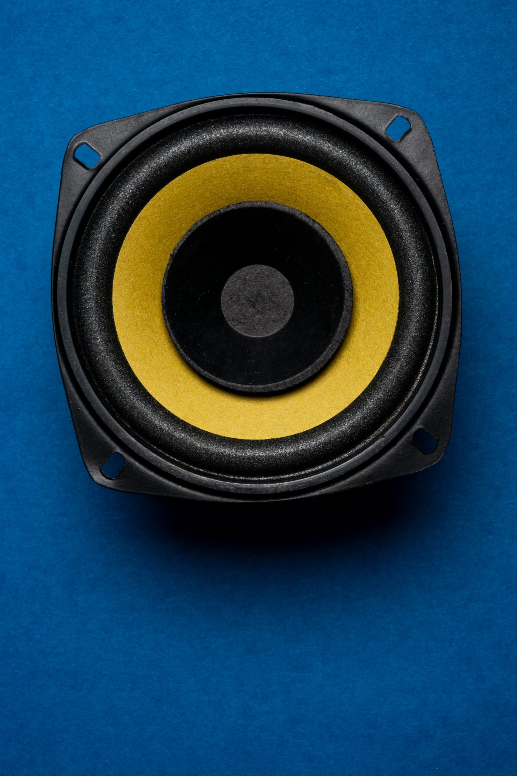 a close up of a speaker on a blue surface